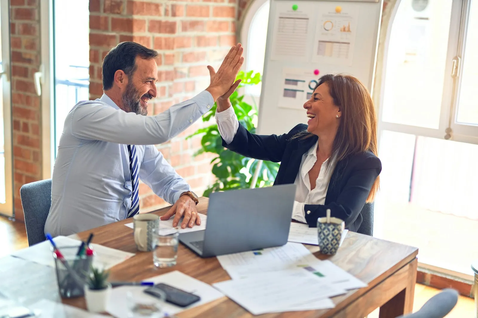 Two professionals shaking hands after a successful audit